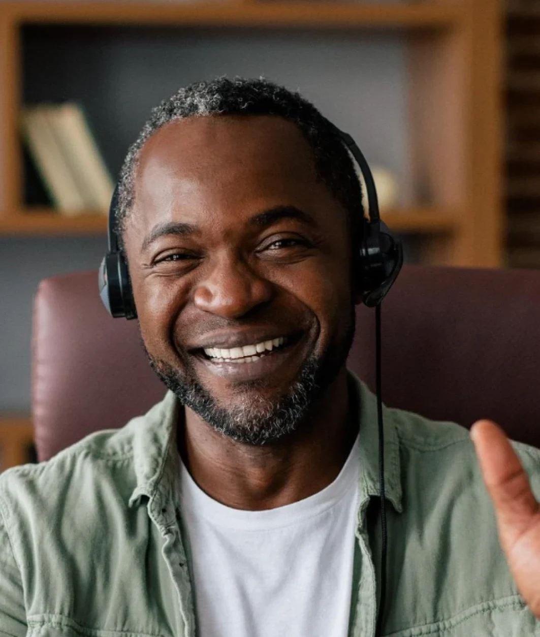 Smiling coach with a headset presenting on a webinar